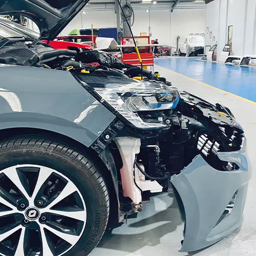 Front-end collision damage on a car waiting for repair