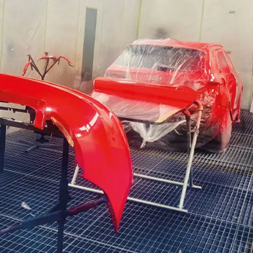 Freshly painted red panels in the paint booth